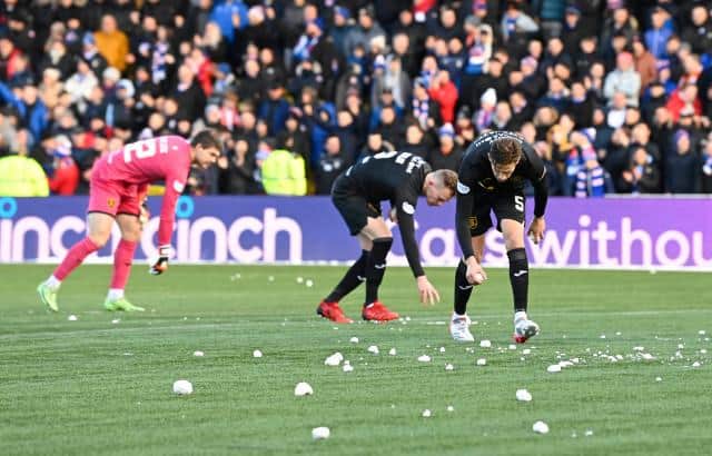 Livingston's players pick up snow balls during a Cinch Premiership match between Livingston and Rangers at Toni Macaroni Arena, on November 28, 2021.  (Photo by Rob Casey / SNS Group)