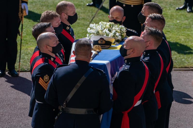 The Duke of Edinburgh's coffin, covered with his Personal Standard, is carried into St George's Chapel, Windsor Castle, Berkshire, ahead of the funeral of the Duke of Edinburgh.