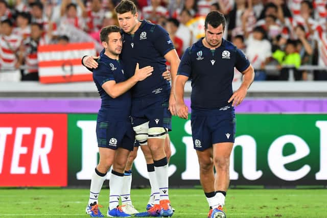 Grant Gilchrist, centre, consoles Greg Laidlaw, with Stuart McInally, right, after Scotland's defeat by Japan at the 2019 Rugby World Cup at the Yokohama International Stadium (Photo by Gary Hutchison/ SNS Group)