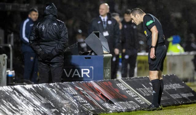 Referee Euan Anderson peers at the VAR screen during St Mirren's 2-2 draw against St Johnstone during the week.