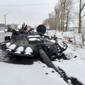 The gun turret of a destroyed Russian tank lies on the road near the city of Kharkiv, which has come under heavy attack by Vladimir Putin's finances (Picture: Sergey Bobok/AFP via Getty Images)