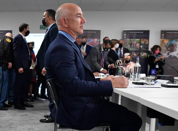US CEO of Amazon Jeff Bezos waits before a meeting with Nigeria's president, Britain's Prince of Wales and France's president as part of the World Leaders' Summit of the COP26 UN Climate Change Conference in Glasgow on November 1, 2021. Photo by ALAIN JOCARD/AFP via Getty Images.