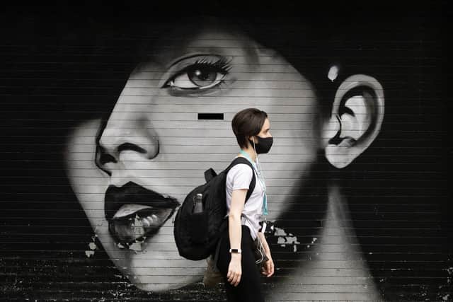 A woman wearing a protective face mask walks through Glasgow city centre. Picture: Jane Barlow/PA Wire