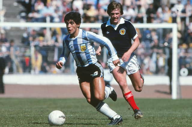 Diego Maradona is chased by Kenny Dalglish during the 1979 friendly at Hampden Park. Argentina beat Scotland 3-1. Picture: Colorsport/Shutterstock