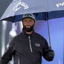 Jon Rahm shelters under his umbrella on a wet practice day for the 151st Open at Royal Liverpool. Picture: Warren Little/Getty Images.