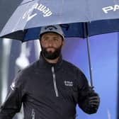 Jon Rahm shelters under his umbrella on a wet practice day for the 151st Open at Royal Liverpool. Picture: Warren Little/Getty Images.