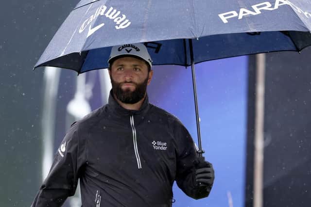 Jon Rahm shelters under his umbrella on a wet practice day for the 151st Open at Royal Liverpool. Picture: Warren Little/Getty Images.