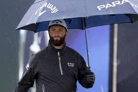 Jon Rahm shelters under his umbrella on a wet practice day for the 151st Open at Royal Liverpool. Picture: Warren Little/Getty Images.