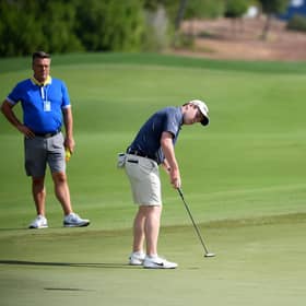 Bob Macintyre is watched by his coach, David Burns, during the pro-am event prior to the DP World Tour Championship at Jumeirah Golf Estates. Picture: Ross Kinnaird/Getty Images