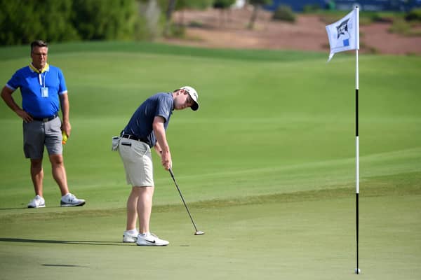 Bob Macintyre is watched by his coach, David Burns, during the pro-am event prior to the DP World Tour Championship at Jumeirah Golf Estates. Picture: Ross Kinnaird/Getty Images