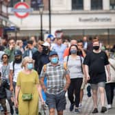 People wearing face masks among crowds of pedestrians in Covent Garden, London. Prime Minister Boris Johnson is expected to scrap social distancing and mask-wearing requirements on England's so-called "Freedom Day" of July 19. Photo: Dominic Lipinski/PA Wire