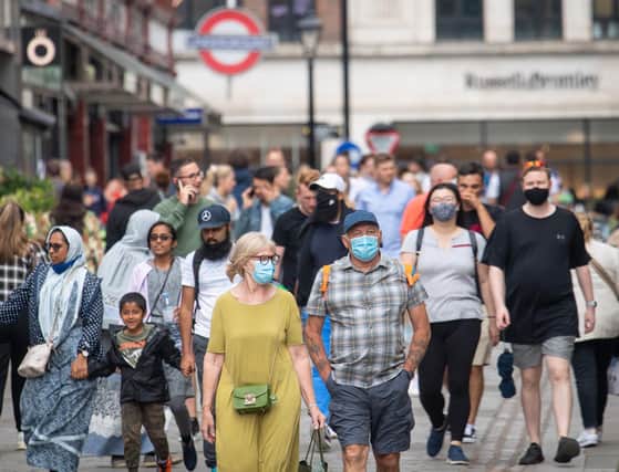People wearing face masks among crowds of pedestrians in Covent Garden, London. Prime Minister Boris Johnson is expected to scrap social distancing and mask-wearing requirements on England's so-called "Freedom Day" of July 19. Photo: Dominic Lipinski/PA Wire