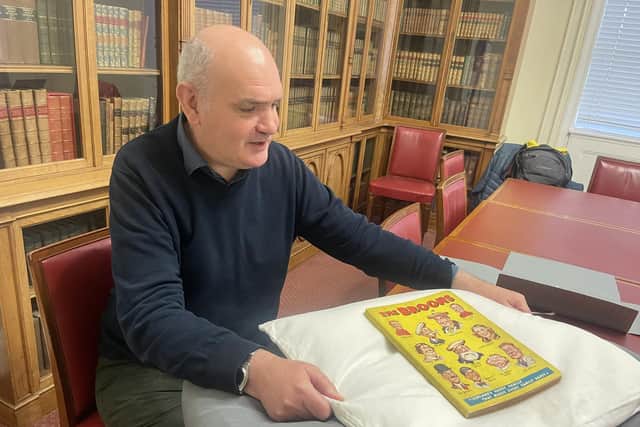 National Library curator Ian Scott with its newly-acquired first edition of The Broons annual.