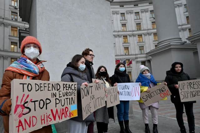 Protesters hold placards during a rally outside of the Ukrainian Ministry of Foreign Affair in Kyiv at the weekend.