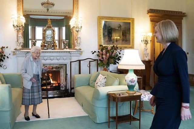 Queen Elizabeth II, left, smiles at Liz Truss during an audience at Balmoral, Scotland, where she invited the newly elected leader of the Conservative party to become Prime Minister and form a new government,