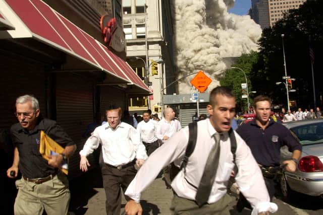 People run away from the collapsing World Trade Center