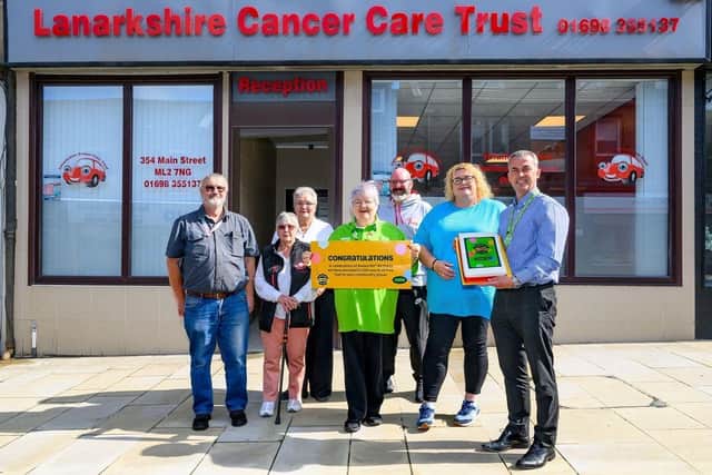 Asda Coatbridge Community Champion Ann Binks and GSM Kevin McPhee surprised Lanarkshire Cancer Care Trust with a 'Golden Ticket' for £1,500 worth of free fuel