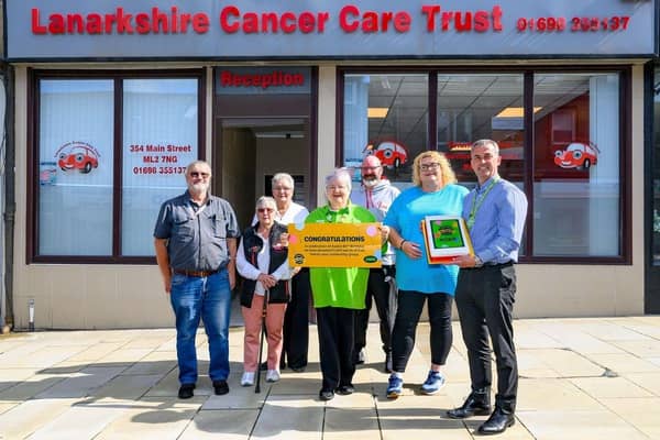Asda Coatbridge Community Champion Ann Binks and GSM Kevin McPhee surprised Lanarkshire Cancer Care Trust with a 'Golden Ticket' for £1,500 worth of free fuel