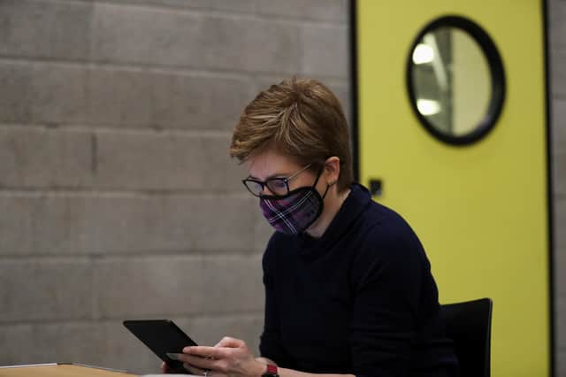 First Minister of Scotland Nicola Sturgeon wears a protective face mask as she waits to receive her booster jab of the coronavirus vaccine in Glasgow this month.