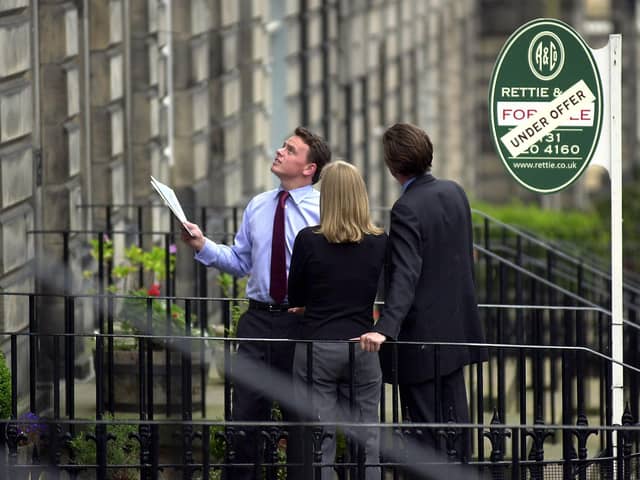 Estate agent showing a property (picture taken before current restrictions).