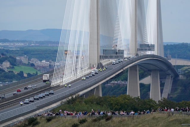 The hearse carrying the coffin of Queen Elizabeth II, draped with the Royal Standard of Scotland, passing over the Queensferry Crossing as it continues its journey to Edinburgh from Balmoral. Picture date: Sunday September 11, 2022.