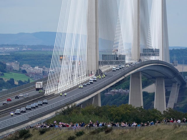 The hearse carrying the coffin of Queen Elizabeth II, draped with the Royal Standard of Scotland, passing over the Queensferry Crossing as it continues its journey to Edinburgh from Balmoral. Picture date: Sunday September 11, 2022.