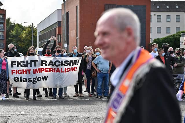 In an image from earlier in the day, an Orange parade passes Blessed John Dun Scotus in the Gorbals where a counter protest by Call It Out had gathered (Photo by Jeff J Mitchell/Getty Images).