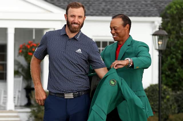 Dustin Johnson receives his Green Jacket from 2019 champion Tiger Woods after winning the Masters at Augusta National. Picture: Jamie Squire/Getty Images