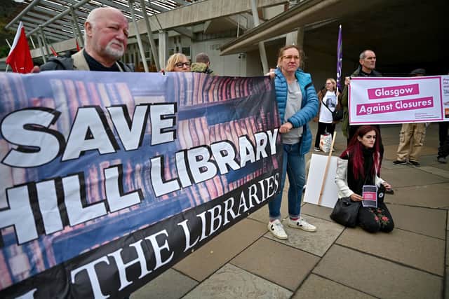 Demonstrators protest outside the Scottish Parliament against library closures in 2021, and some facilities remain threatened today (Picture: Jeff J Mitchell/Getty Images)