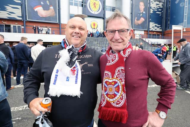 A Rangers' fan and a Heart's fan outside the stadium before the Scottish Cup final at Hampden Park, Glasgow.