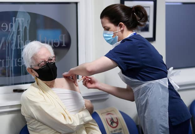 John Elphinstone, 91, receives the Oxford/AstraZeneca coronavirus vaccine, administered by Practice Nurse Marianne Stewart, at Pentlands Medical Centre in Edinburgh.