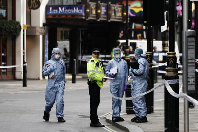 Forensics officers and police at the scene in Shaftesbury Avenue, central London, where two male police officers were stabbed by a man around 6am. Both officers are currently being treated by medics.