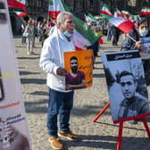 A man holds a portrait of Iranian wrestler Navid Afkari during a demonstration in Amsterdam against his execution in Iran (Picture: Evert Elzinga/ANP/AFP via Getty Images)