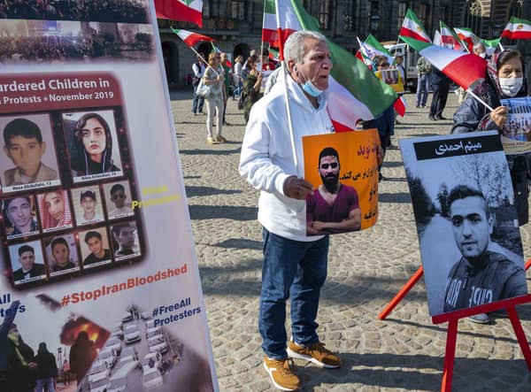 A man holds a portrait of Iranian wrestler Navid Afkari during a demonstration in Amsterdam against his execution in Iran (Picture: Evert Elzinga/ANP/AFP via Getty Images)