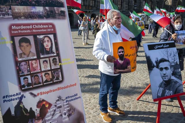 A man holds a portrait of Iranian wrestler Navid Afkari during a demonstration in Amsterdam against his execution in Iran (Picture: Evert Elzinga/ANP/AFP via Getty Images)