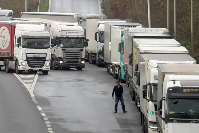 A lorry driver views the queue of lorries on the M20 as lorries wait to enter the Eurotunnel site in Folkestone, Kent, due to heavy freight traffic.