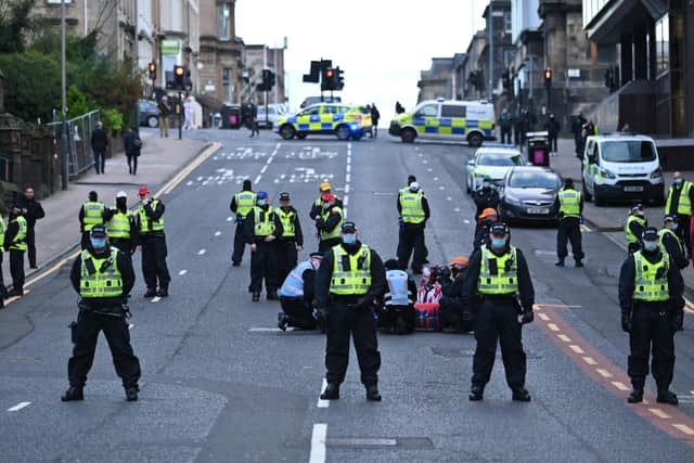 Police officers, who closed St Vincent Street in Glasgow after Amazon and Extinction Rebellion staged a protest aimed at Santander.