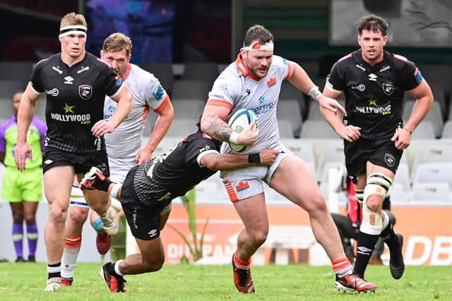 The Sharks pounce on Edinburgh's Ewan Ashman as he tries to break.