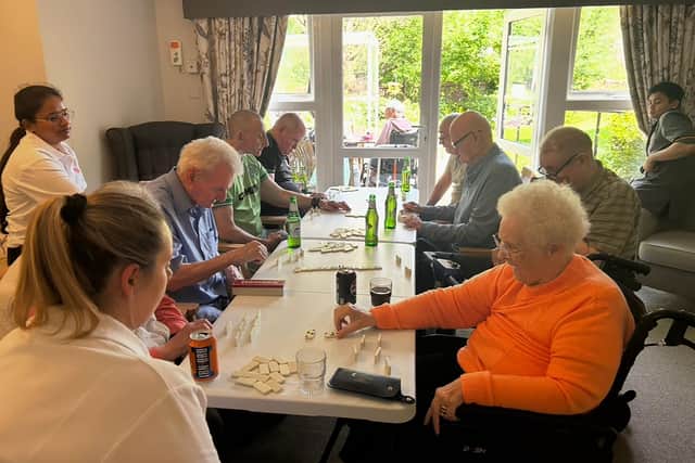 Residents at HC-One Scotland’s Eastbank Care Home participating in dominoes tournament during Care Home Open Week 2025