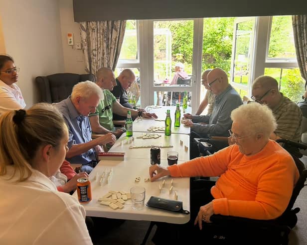 Residents at HC-One Scotland’s Eastbank Care Home participating in dominoes tournament during Care Home Open Week 2025