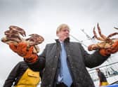 Boris Johnson holds crabs caught on the Carvela at Stromness Harbour during a visit to Scotland (Picture: Robert Perry/PA Wire)