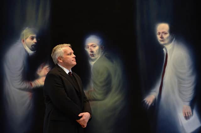 Christopher Baker, director of European and Scottish art and portraiture at the National Galleries of Scotland, poses in front of the Three Oncologists by Ken Currie (Picture: Jeff J Mitchell/Getty Images)