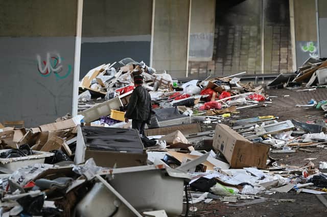 Mounds of illegally dumped rubbish pictured in August piled beneath the M8 in Riddrie, Glasgow (Picture: John Devlin)