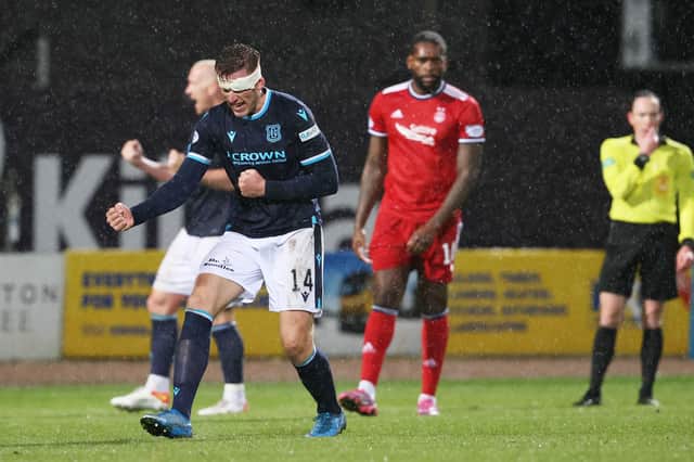 Dundee's bandaged centre-half Lee Ashcroft celebrates at full time after the 2-1 win over Aberdeen at Dens Park. (Photo by Alan Harvey / SNS Group)
