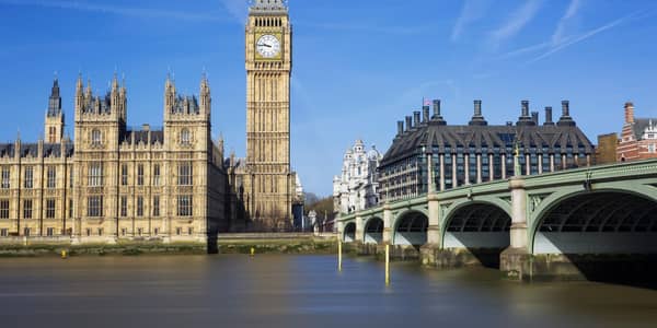 The Big Ben and Palace of Westminster under a clear blue London sky.