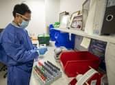 A pathology trainee biomedical scientist (BMS) in microbiology, prepares Covid-19 tests for analysis in the laboratory at Whiston Hospital in Merseyside in October 2020.