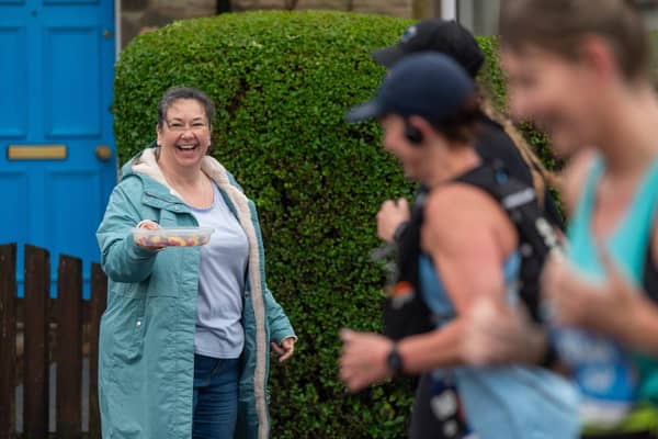 A supporter with supplies cheers on runners in the Edinburgh Marathon. Picture: Andrew O'Brien