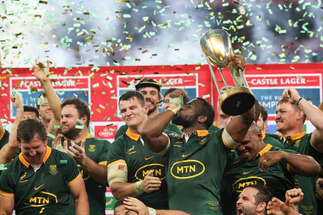 South Africa's captain Siya Kolisi lifts the trophy as he celebrates with his teammates after the Springboks won the Rugby Championship by beating Argentina at Mbombela Stadium in Nelspruit. (Photo by PHILL MAGAKOE/AFP via Getty Images)