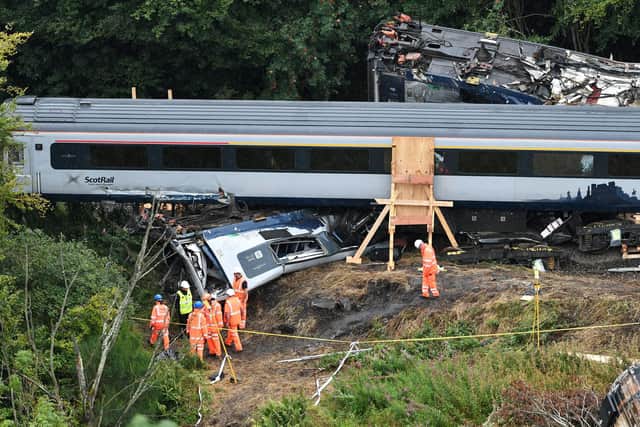 The wreckage of the first coach in the Carmont crash lies underneath the fourth coach. Picture: John Devlin