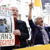 Supporters of the People's Mojahedin of Iran protest outside a Stockholm court on the first day of the trial of an Iranian man for war crimes over the execution of political prisoners in 1988 in Karaj, Iran (Picture: Stefan Jerrevang/TT NEWS AGENCY/AFP via Getty Images)